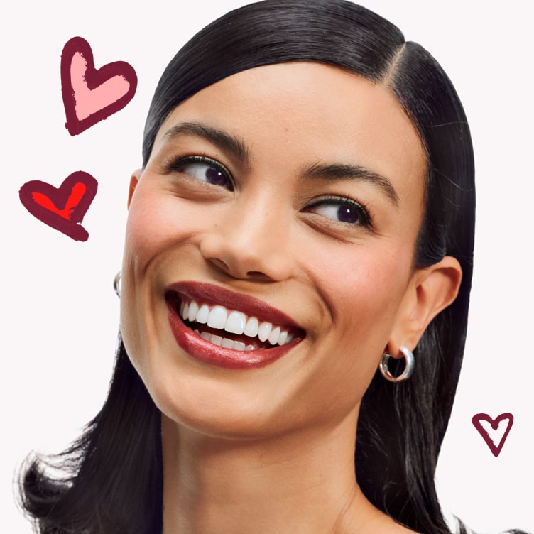 two hands holding a bunch of travel size clinique products to showcase offers 