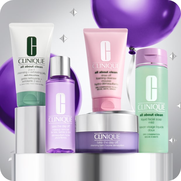 Selection of best-selling Clinique cleansers on a grey plinth, surrounded by purple balloons